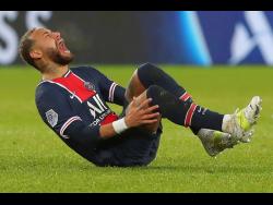 PSG’s Neymar falls in pain during the League One football match between Paris Saint Germain and Lyon, at the Parc des Princes stadium in Paris, France, Sunday, December 13, 2020. 