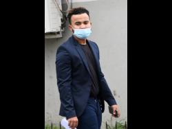 Kyle Butler leaves the Half-Way Tree Resident Magistrate’s Court yesterday.