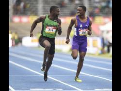 Calabar High School’s Tyreke Wilson (left) shares a laugh with Jhevaughn Matherson of Kingston College during the preliminary round of the Class One boys’ 100m at the ISSA/GraceKenedy Boys and Girls’ Athletics Championships on March 23, 2018.