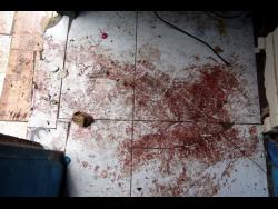 The bloodstained floor of the Penn Street dwelling where Jenell Thomas and her brother Omar Jarrett were killed Monday night.