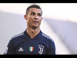 Juventus’ Cristiano Ronaldo walks on the pitch during the Serie A match between Juventus and Bologna, at the Allianz Stadium in Turin, Italy, Sunday, January 24, 2021. 