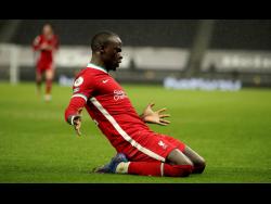 Liverpool’s Sadio Mane celebrates scoring his side’s third goal during the English Premier League match between Tottenham Hotspur and Liverpool at the Tottenham Hotspur Stadium in London, yesterday.