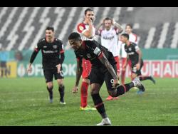 Bayer Leverkusen’s Leon Bailey celebrates after scoring his side’s first goal during the German Soccer Cup third-round match against RW Essen  in Essen, Germany, yesterday.