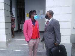 Dancehall artiste Beenie Man (left) chats outside the St Elizabeth Parish Court in Black River with his attorney Roderick Gordon, after pleading not guilty to charges of breaching the Disaster Risk Management Act and Noise Abatement Act yesterday morning.