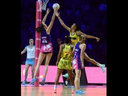 Jamaica goalkeeper Shamera Sterling (second right) goes high to defend ahead of Scotland goal shooter Emma Barrie (left), while Jamaica’s Adean Thomas (second left) and Lynsey Gallagher(GA) look on during their Vitaly Netball World Cup Group G game at the M&S Bank Arena in Liverpool, England, on July 17, 2019.