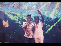 Surprise guest for the show, Popcaan (right) gets caught up in his performance with Beres.