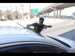 Solomon wipes the windscreen of a motorist.