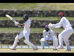 Sri Lanka’s Lahiru Thrimanne gathers runs against the West Indies on day three of the first Test in Antigua yesterday.