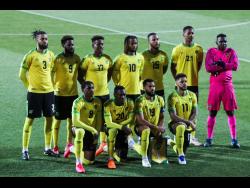 Jamaica players stand during the national anthem prior the international friendly soccer match between USA and Jamaica at SC Wiener Neustadt stadium in Wiener Neustadt, Austria, Thursday, March 25, 2021. 