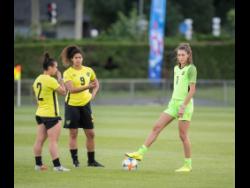 Reggae Girlz (from left) Lauren Silver, Marlo Sweatman, and Sydney Schneider in discussion during a training session at Stade Eugene Thenard in Grenoble, France, on Monday, June 17, 2019.