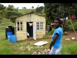 Natasha Rhoden stands in front her one-room board house in Pleasant Hill, Lluidas Vale, St Catherine.