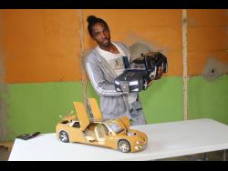 Oshane Dunstan shows off his model cars.