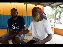 Samson ‘Jeffrey’ Bryan (left) and drummer Artnell ‘Sengeh’ Bernard talk about the longing for Kumina events in their St Thomas community.