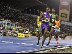(From left) Renardo Johnson, of St Jago High School, Arymanya Rodgers, of Kingston College, and 5000m run winner Kevroy Venson of Calabar High School at the ISSA/GraceKennedy Boys and Girls’ Athletics Championships at the National Stadium on Saturday, March 24, 2018.
