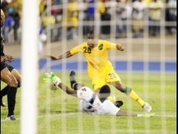 Jamaica’s Tremaine Stewart moves past Antigua and Barbuda’s goalkeeper Molvin James during a World Cup qualifier at the National Stadium in 2012.