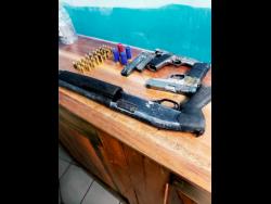 The three illegal guns and ammunition seized on Wednesday by the security forces in Woodside, Clarendon.