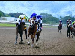 File
ANOTHER AFFAIR (right), ridden by Robert Halledeen, wins the Supreme Ventures Games People Love to Play Trophy ahead of LABAN (left) at Caymanas Park on Sunday, December 27, 2020.