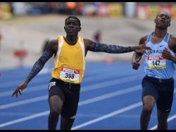 Antonio Watson from Petersfield High School (left) celebrates after winning the Class One boys 200m final at the ISSA/GraceKennedy Boys and Girls’ Athletics Championships at the National Stadium on Saturday, May 15, 2021.
