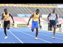 Bryan Levell (right) picks up points for Edwin Allen High School in the Class One Boys 100m final.  Sachin Dennis (centre) of St Elizabeth Technical High School took the gold medal, while Antonio Watson of Petersfield High School took silver.