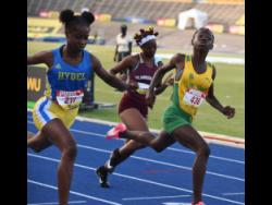 Camoy Binger (right) of  St Jago High wins the Class Three girls 80 metres hurdles final in 11.14 seconds ahead of Jody-Ann Daley of Hydel High (left) and Kiara Meikle (centre) of Holmwood Technical. The action is from last week’s ISSA/GraceKennedy Boys and Girls’ Championships.