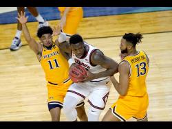 Illinois’s Kofi Cockburn (centre) is pressured by Drexel’s Camren Wynter (11) and Tim Perry Jr during a first round NCAA college basketball  game on March 19, 2021.
