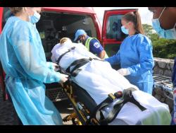 Nicola Clarke is transported by medical personnel from the Cornwall Regional Hospital to the Sangster International Airport in Montego Bay. She was flown to the JMS Burn Center at Doctors Hospital, in Augusta, Georgia, USA, for treatment.