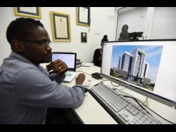 Matthews shows off one of his architectural designs that will be constructed soon in the Corporate Area.