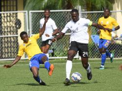 Cavalier’s captain Kamoy Simpson (right) powering past Harbour View’s Cristojaye Daley during yesterday’s Jamaica Premier League match at the UWI/Captain Horace Burrell Centre of Excellence.  The game ended 1-1.