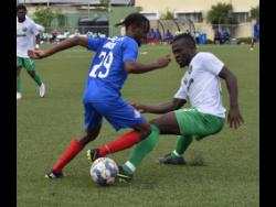  Tajay Brown (left) of Portmore United getting the better of  Vere United’s Alton Lewis during  a Jamaica Premier League match at the UWI/Captain Horace Burrell Centre of Excellence yesterday. Vere won 1-0.
