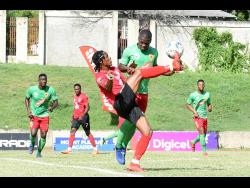 Steve Clarke (left) of Arnett Gardens attempts to control the ball ahead of  Humble Lion’s Lorenzo Lewin in action from yesterday’s Jamaica Premier League match at the Stadium East field. Arnett won 2-1. 