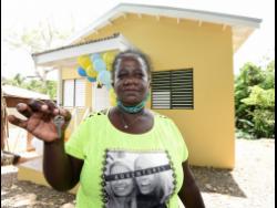 Dawnette Henry shows the keys to her new house in Gayle, St Mary, which was built under the new Social Housing Programme. 