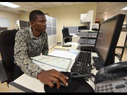 Omar Moodie, a former windshield wiper, is now a record officer at the Ministry of Housing, Urban Renewal, Environment and Climate Change. 