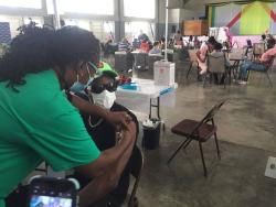 Dancehall artiste Ding Dong getting vaccinated at the Girl Guides headquarters in St Andrew.