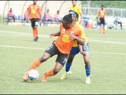 Kemar Flemmings (left) of Tivoli Gardens FC  shielding the ball from Harbour View’s Odorland Harding during a Jamaica Premier League match at the UWI/Captain Horace Burrell Centre of Excellence last Saturday.  Flemmings scored the opening goal in Tivoli’s 3-1 win.