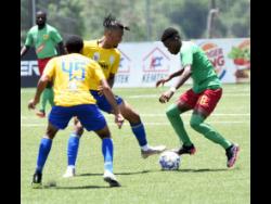 Humble Lion’s Shemar Rhoden  (right) attempting to get past Renaldo Wellington (left) and Oquassa Chong (centre) of  Harbour View during their Jamaica Premier League football match at the UWI/Captain Horace Burrell Centre of Excellence yesterday. Humble Lion won 2-0.