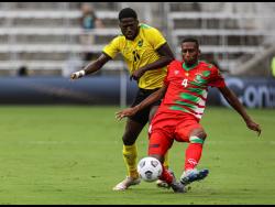 Jamaica's Shamar Nicholson (left) in action against Suriname's Dion Malone during a Concacaf Gold Cup match on July 12  in Orlando, Florida.