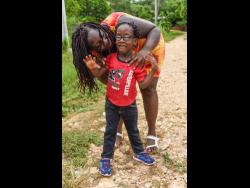 Shanice Rowe poses with her son, Lashaun Rowe, in Zambia, Central Village, St Catherine. Lashaun suffers from a rare medical condition, Walker-Warburg Syndrome, a rare multisystem disorder that tends to claim the lives of children by age three. Lashaun celebrates his sixth birthday this Saturday.