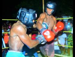 Left: Oraldo ‘Jubba’ Stephenson (left) of Mandella Terrace and Miracle Rhakeam from Cockburn Gardens battle in the ring during a charity boxing clash dubbed ‘Jump Out, Thump Out, in Cockburn Gardens recently. Miracle won the bout.