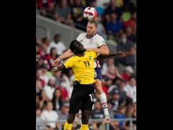 United States’ Walker Zimmerman leaps above Jamaica’s Shamar Nicholson (front) to head the ball during a FIFA World Cup qualifying match  in Austin, Texas, on Thursday, October 7.