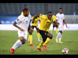 Jamaica's Michail Antonio (right) powers past Panama's Eric Davis Grajes during a FIFA World Cup qualification match at the National Stadium on Sunday, September 5.