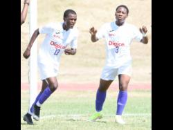 
Rojay Nelson (left) and Khalifah Richards of Kingston College (KC) react after Nelson scored the school’s first goal against Clan Carthy in their ISSA Manning Cup football match at the Stadium East field yesterday. KC won 7-0.