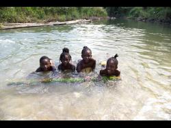 From left: Dantae Lawrence, Sara-key Williams, Mackayla McLennon and Shadeka Williams enjoy the waters of the Rio Cobre.