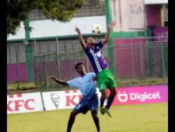 Ahmad Anderson (right) of William Knibb High controls the ball ahead of  Giovanni Frank of Holland High during their first round ISSA/daCosta Cup match at the William Knibb Sports Complex on November 30. Holland won 1-0.