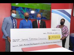 Education Minister Fayval Williams (second left) is flanked by Examinations Officer at the Overseas Examination Commission, Tanjay Holmes (left), JPS Foundation Deputy Chairman, Ramsay McDonald, and JPS Director of Corporate Communications, Winsome Callum. The occasion was the official handing over of the sponsorship cheque for students sitting the Caribbean Secondary Education Certificate Industrial (Electrical) Exam in 2022. 