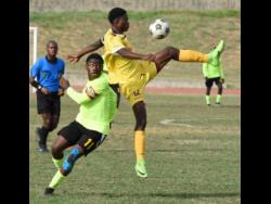 Charlie Smith High School’s Kareem Griffiths (right) gets high above Excelsior High School’s Jhevan Smith to take the ball during their ISSA/Digicel Manning Cup game at Stadium East yesterday.