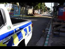 Police cordon off a section of Fleet Street in Kingston where a well-known tailor, Winston Ellis, was murdered yesterday.