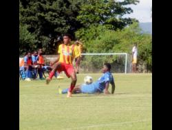Cornwall College’s Devin Johnson (left) loses the ball to a successful tackle by his opponent, Clarendon College’s Ricardo Beckford during an ISSA/WATA daCosta Cup match at the St Elizabeth Technical High School Sports Complex on Saturday, December 11.