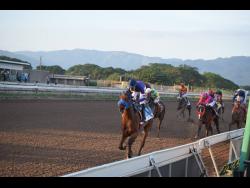 BRINKS (left), ridden by Omar Walker, wins the Pick 3 Super Challenge Trophy, a Restricted Allowance Stakes for two-year-olds over seven furlongs at Caymanas Park on Saturday, November 27.