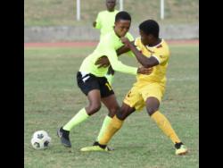 Excelsior High School’s Jevaughnie Simms (left) battles with Charlie Smith High School’s Tevaughn Lowe during their ISSA/Digicel Manning Cup match at Stadium East in Kingston on Wednesday, December 15, 2021.