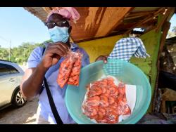 Middle Quarters shrimp vendor Sharon Ball displays her products in her St Elizabeth community on Tuesday.